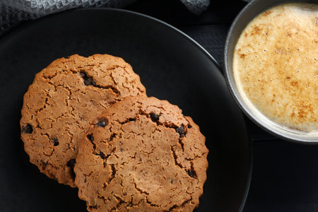 Oatmeal cookies with cappuccino on darkの写真素材