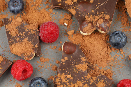 Chocolate with nuts, cocoa and berries. milk chocolate pieces with fruits and nutsの写真素材
