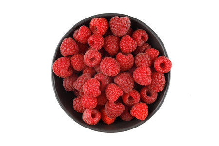 Raspberries in a bowl on white isolate.の写真素材