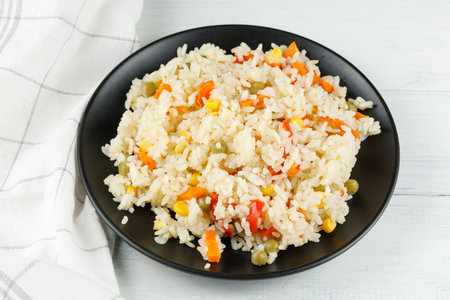 Rice with vegetables in a plate on the table.の写真素材