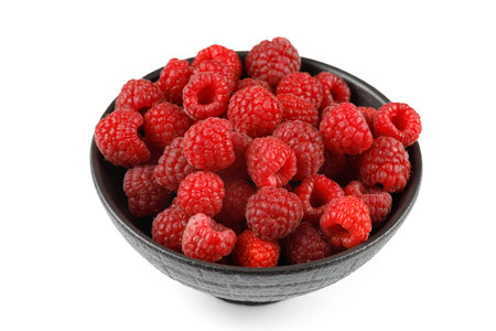Raspberries in a bowl on white isolate.の写真素材