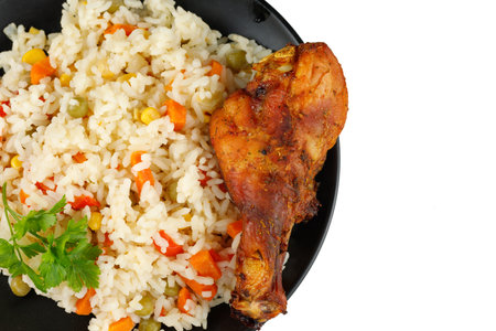 Fried chicken and rice with vegetables in a plate. Tasty and hearty foodの写真素材