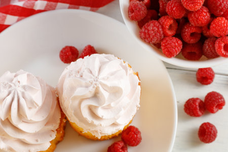 Raspberry cupcakes with berries on a white background.の写真素材