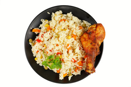 Fried chicken and rice with vegetables in a plate. Tasty and hearty foodの写真素材