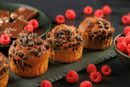 Chocolate muffin with berries. Appetizing cupcakes on a dark background.の写真素材