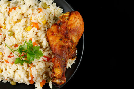 Fried chicken and rice with vegetables in a plate. Tasty and hearty foodの写真素材