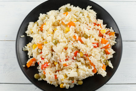Rice with vegetables in a plate on the table.の写真素材