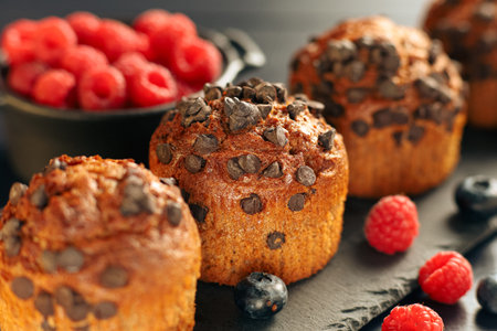 Chocolate muffin with berries. Appetizing cupcakes on a dark background.の写真素材