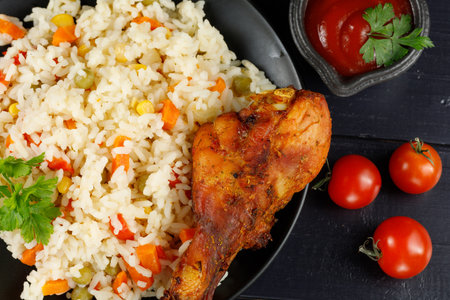 Fried chicken and rice with vegetables in a plate. Tasty and hearty foodの写真素材