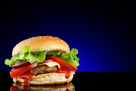 Appetizing burger place for text cope space. burger with lettuce, tomato, cheese and sauceの写真素材
