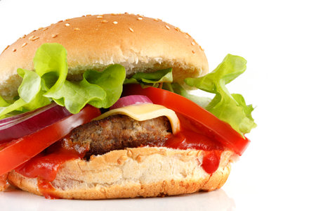 Tasty burger close-up place for text cope space. Burger with tomatoes, greens, onions and meat.の写真素材