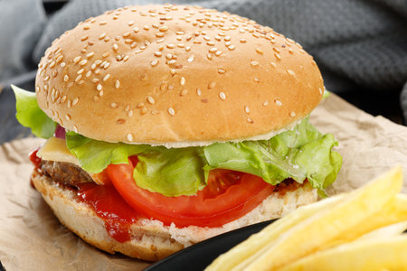 Tasty burger close-up. home made beef burger with tomato, cheese, beef and salad.の写真素材