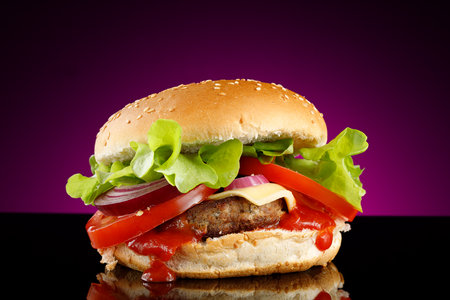 Tasty burger close-up. home made beef burger with tomato, cheese, beef and salad.の写真素材