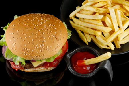 Burger with sauce and french fries. Delicious grilled burgersの写真素材