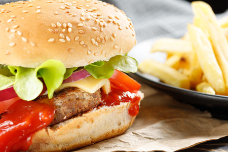 Tasty burger close-up. home made beef burger with tomato, cheese, beef and salad.の写真素材
