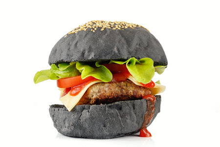 Black burger homemade. Juicy black burger isolate on white.の写真素材