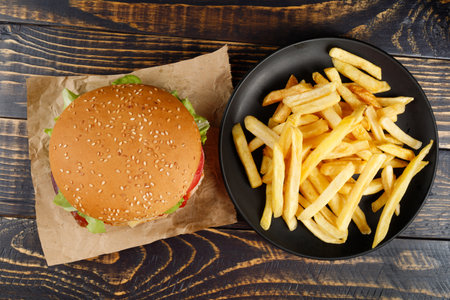 burger with lettuce, tomato, cheese and cutlet top view.の写真素材