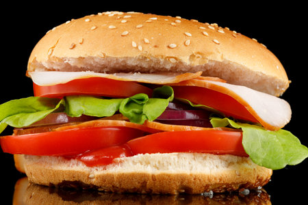 Tasty burger close-up. home made beef burger with tomato, cheese, beef and salad.の写真素材