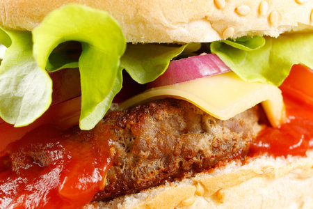 Burger with cutlet, tomato, cheese and greens. Fresh tasty burger isolated on black background. Classic Burger close upの写真素材