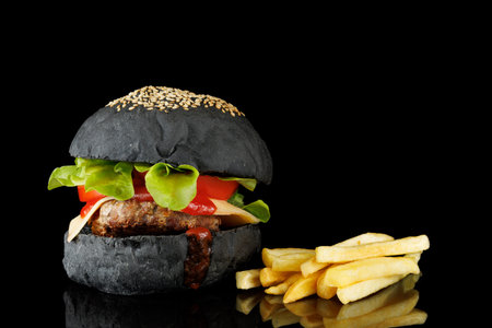 Black burger and french friesの写真素材