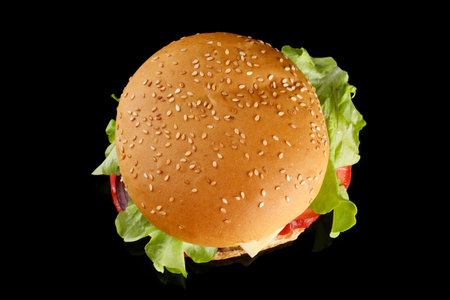Burger appetizing top view on black. Meat hamburger flat layの写真素材