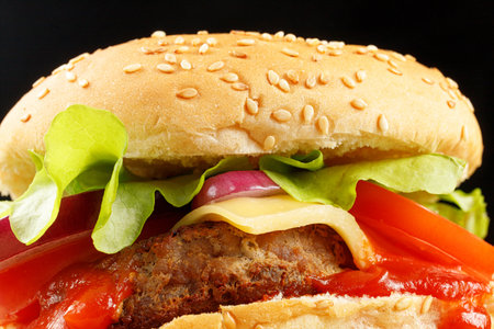 Tasty burger close-up. Burger with tomatoes, greens, onions and meat. Classic Burger close upの写真素材