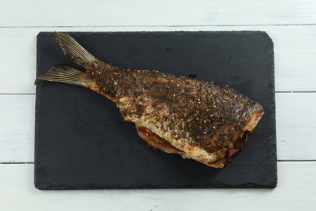 Baked fish on the table. baked carp.の写真素材