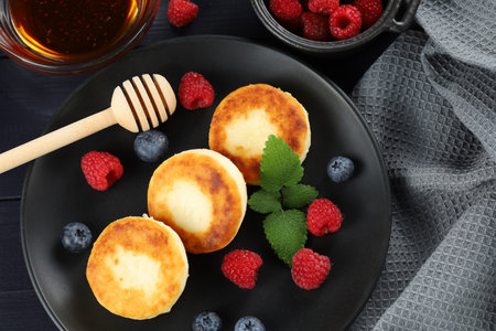 Cottage cheese fritters in a plate with berries.の写真素材