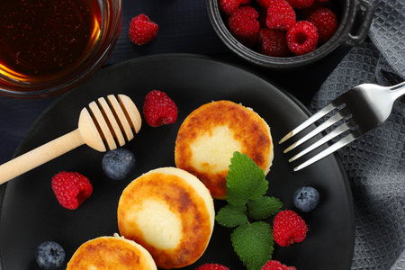 curd fritter with berries in a plate. cottage cheese fritters.の写真素材