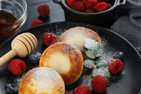 Cottage cheese fritters with raspberry berries. traditional breakfast. Tasty and healthy food.の写真素材
