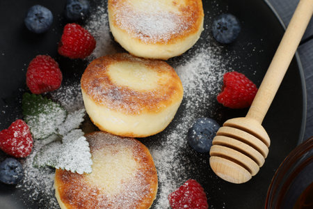 Cottage cheese fritters with raspberry berries. Cottage cheese pancakes, syrniki, curd fritters with fresh berriesの写真素材