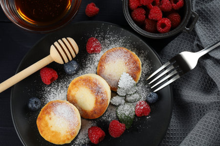 curd fritter with berries in a plate. cottage cheese fritters.の写真素材