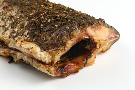 Baked fish on the table. Baked carp isolated on white.の写真素材