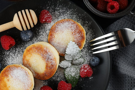 Cottage cheese fritters in a plate with berries.の写真素材