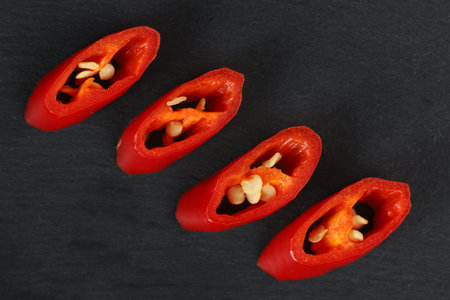 Red hot pepper sliced on slate.の写真素材