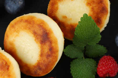 curd fritter with berries in a plate. cottage cheese fritters.の写真素材