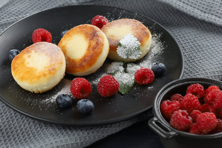 Cottage cheese fritters with raspberry berries. traditional breakfast. Tasty and healthy food.の写真素材