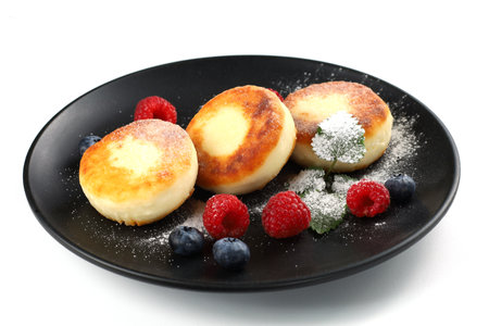 Cottage cheese fritters with raspberry berries. traditional breakfast. Tasty and healthy food.の写真素材