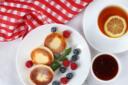 Cottage cheese fritters in a plate with berries.の写真素材