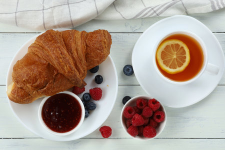 Croissant with jam and berries. traditional breakfast.の写真素材