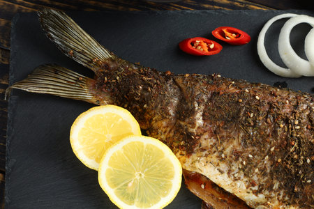 Fried carp fish tail with lemonの写真素材