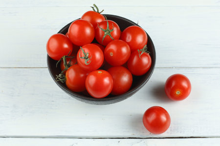 Red cherry tomato in a bowlの写真素材