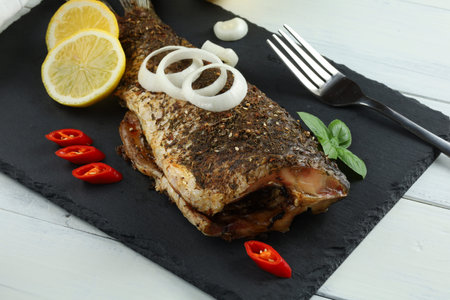 Baked fish on the table. baked carp. fish for dinnerの写真素材