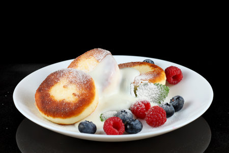 Cottage cheese fritters with yogurt or creamの写真素材