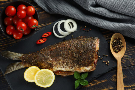 Baked fish on the table. baked carp. served fried carpの写真素材