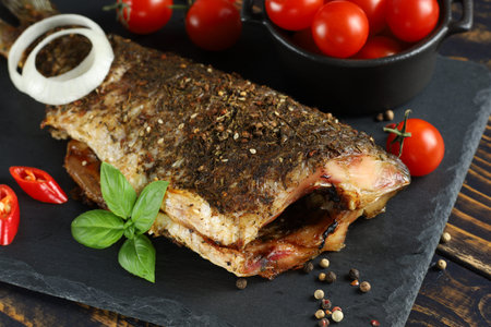 Baked fish on the table. baked carp. baked fish with vegetablesの写真素材