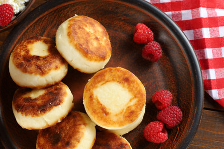 curd fritters and raspberries. Cheese fritters, pancakes or syrnikiの写真素材