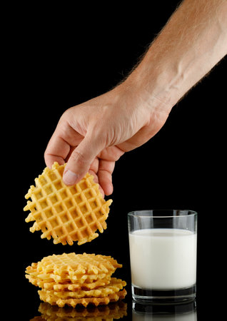 Belgian waffles with milk on black.の写真素材
