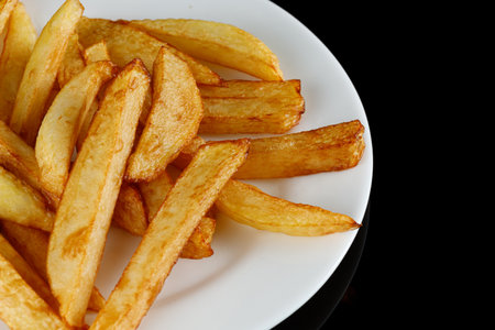 French fries on a white plate. Tasty potato fries for food or snackの写真素材
