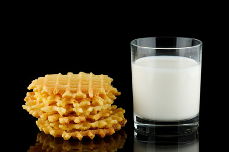 Belgian waffles with milk on black.の写真素材